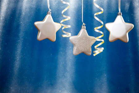 Holiday background with golden christmas decorations and magic holiday light.