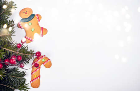 Christmas background with gingerbread cookies and pine tree branch on white.の写真素材