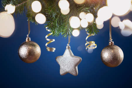 Holiday background with golden christmas decorations and magic holiday light.の写真素材