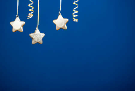 Holiday background with golden christmas decorations and magic holiday light.の写真素材