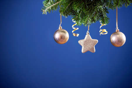 Holiday background with golden christmas decorations and magic holiday light.の写真素材