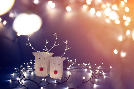 Reindeers in sparkling Christmas light - holiday background