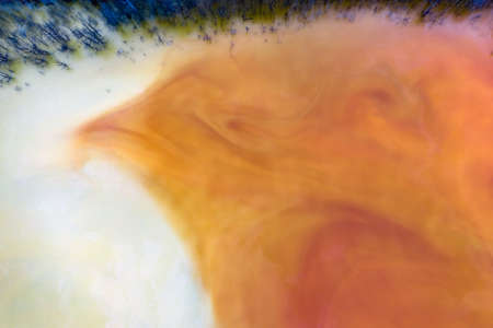 Beautiful aerial pattern of colorful water and mud, shot with a drone located at Geamana, Romania, a...