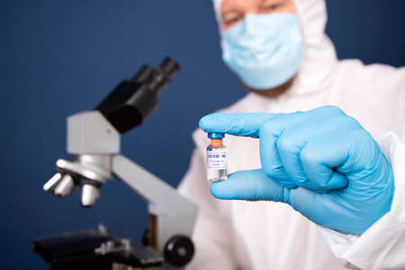 Coronavirus, covid-19 vaccine in hands of pharmacuetical bio research scientist in vaccine development laboratoryの写真素材