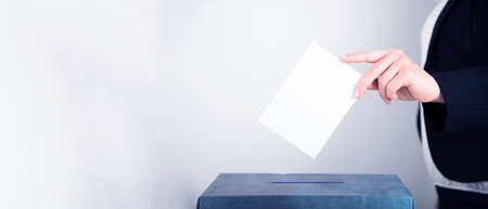 Banner of a voter putting vote in the ballot box. Election concept.の写真素材