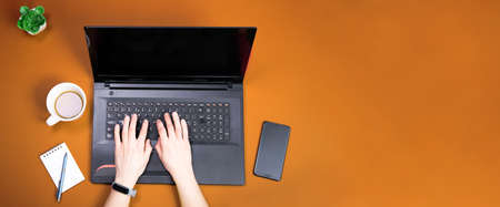 Top view of person working on a laptop computer