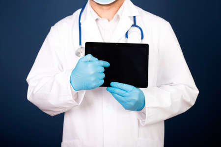 Male doctor using his digital tablet in the consultation.Medicine and healthcare conceptの写真素材