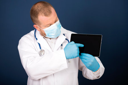 Male doctor using his digital tablet in the consultation.Medicine and healthcare conceptの写真素材