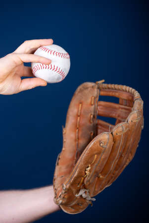 Close up image of an old used baseball and baseball glove.の写真素材