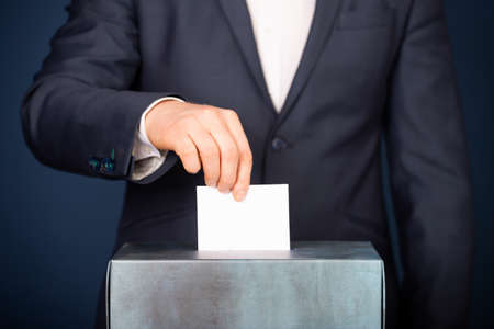 Voter putting vote in the ballot box. Election concept.の写真素材