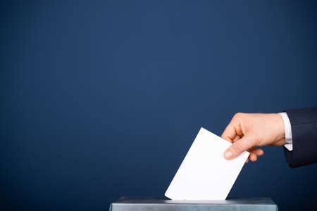 Voter putting vote in the ballot box. Election concept.の写真素材