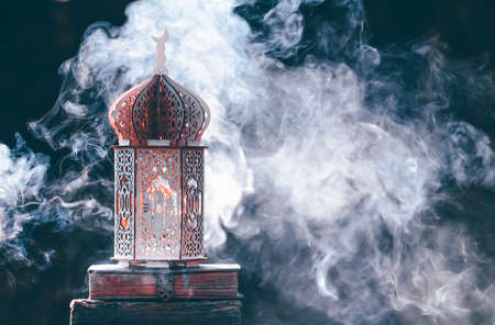 Ornamental Arabic lantern with with Holy Quran. Festive greeting card for Muslim holy month Ramadan Kareem.の写真素材