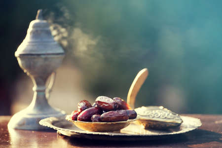 Festive greeting card for Muslim holy month Ramadan Kareem with dates, Quaran and censerの写真素材