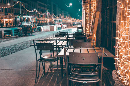 Tables of a milanese outdoor cafe decorated for Christmas.の写真素材