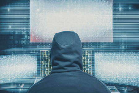 Hacker coding virus ransomware using laptops and computers. Cyber attack, system breaking and malware concept.の写真素材