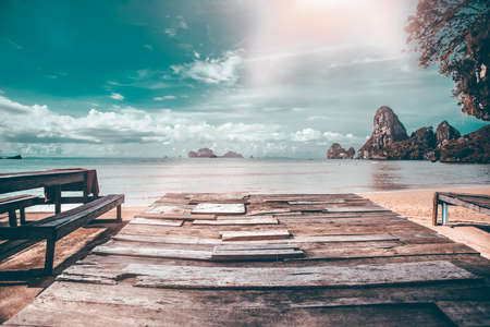 Empty wooden planks with tropical islands and beach in the background.の写真素材