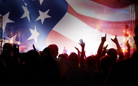 Crowd of people celebrating Independence Day. United States of America USA flag with fireworks background for 4th of July.の写真素材