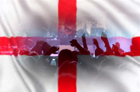 Football fans supporting England - crowd celebrating in stadium with raised hands against England...