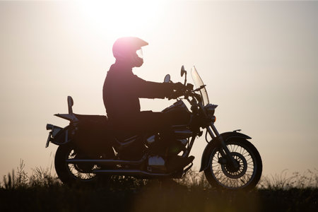 Motorcycle driver riding on countryside. Travel and sport, speed and freedom conceptの写真素材