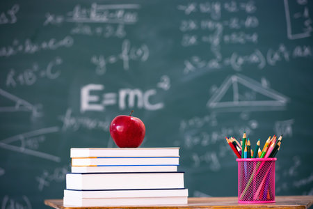 Back to School Concept. Apple, accessories and books against chalkboard.の写真素材