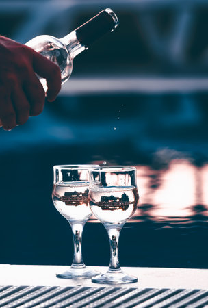 Summer party, wine in glasses near the swiming pool, summer drinks, relaxing by the waterの写真素材