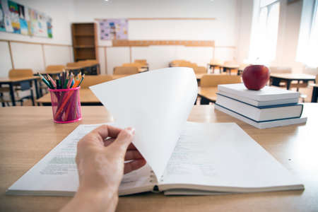 Back to School Concept. Accessories and books, blurred classroom in the backgroundの写真素材