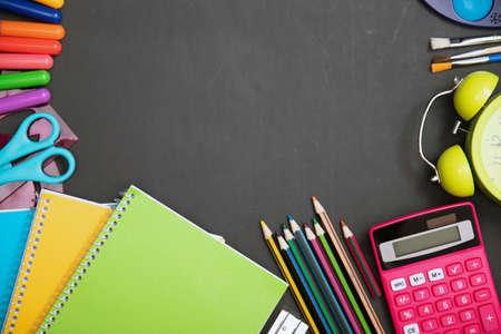 Education, back to school concept. School supplies on blackboard with copy space.
