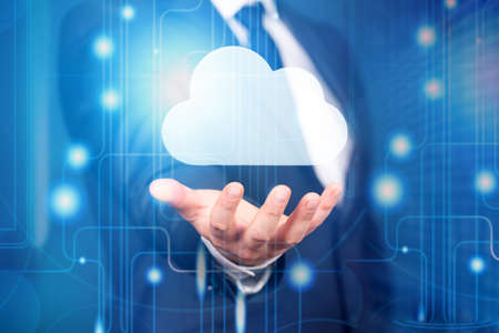 Businessman or information technologist with cloud computing icon. Cloud computing concept - connect...