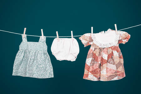 Baby clothes hanging on the clothesline.の写真素材