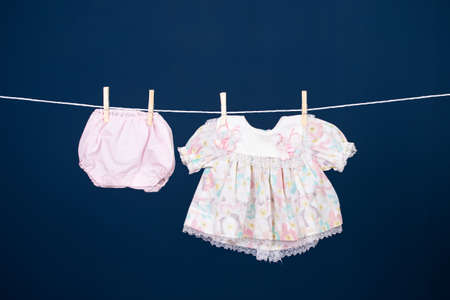 Baby clothes hanging on the clothesline.の写真素材