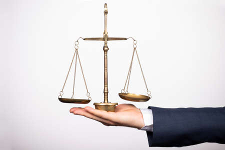 Weight scale of justice, lawyer in background. Justice, law, attorney, authority conceptの写真素材