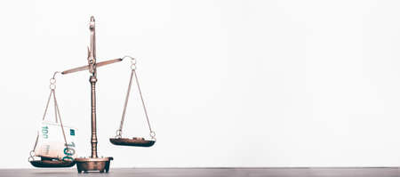 Balance scale with coin stacks. Money management, time value of money and saving money concept.の写真素材