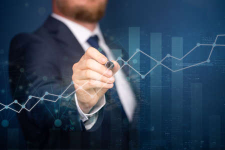 Businessman analysing stock market indicators or financial data and charts for best investment...