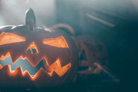 Jack O' Lanterns glowing in smoky fantasy night. Halloween background