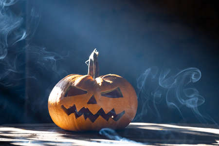 Jack O' Lanterns glowing in smoky fantasy night. Halloween backgroundの写真素材