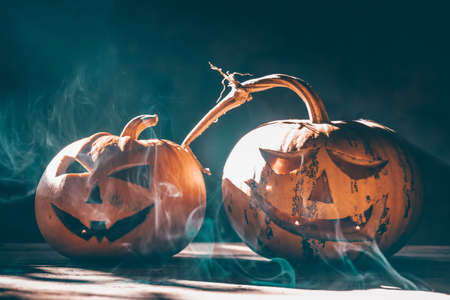 Jack O' Lanterns glowing in smoky fantasy night. Halloween backgroundの写真素材