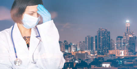 Double exposure of doctor with medical mask and gloves and cityscape. Healthcare and medical during virus pandemic conceptの写真素材