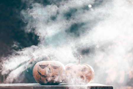 Jack O' Lanterns glowing in smoky fantasy night. Halloween backgroundの写真素材