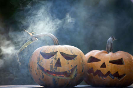 Jack O' Lanterns glowing in smoky fantasy night. Halloween backgroundの写真素材