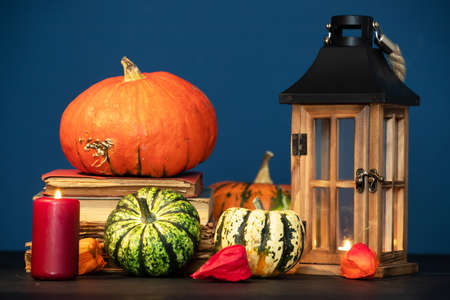 Rustic autumn still life with pumpkins and old lantern. Halloween and Thanksgiving concept.