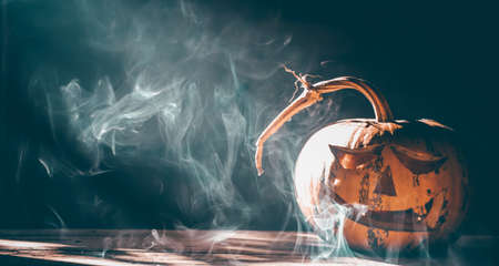 Jack O' Lanterns glowing in smoky fantasy night. Halloween backgroundの写真素材