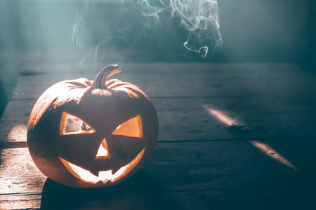 Jack O' Lantern glowing in smoky fantasy night. Halloween background