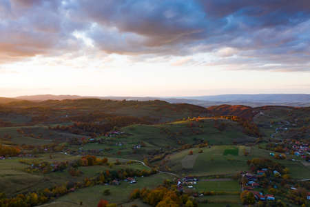 Aerial view of authentic traditional villages from Apuseni area in Romania during autumn sunset