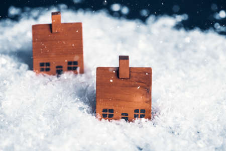 Merry Christmas and Happy Holidays! Cute little wooden houses in winter snowの写真素材