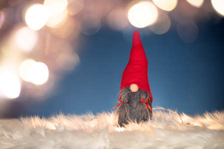 Merry Christmas and Happy Holidays! Cute little nordic  gnome with Christmas lightsの写真素材
