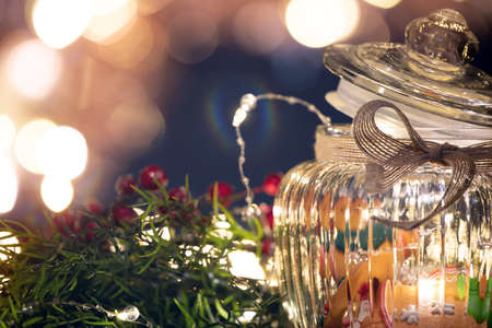 Christmas moody style background with candy jar and Christmas decoration on sparkling lightsの写真素材