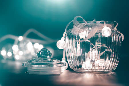 Christmas moody style background with candy jar and Christmas decoration on sparkling lightsの写真素材