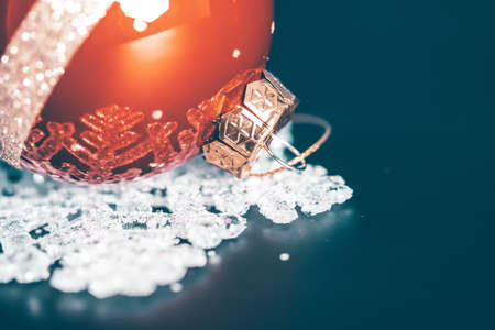 Magic holiday background with christmas ball on white snowflake decorationの写真素材