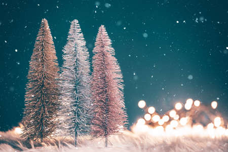 Magic holiday blue background with christmas tree, snowflakes and holiday lightsの写真素材