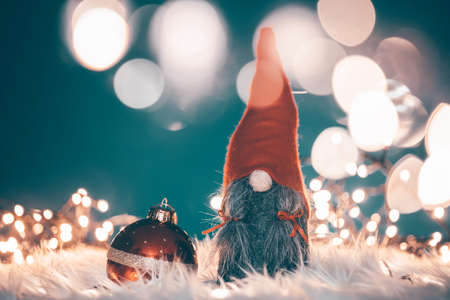 Merry Christmas and Happy Holidays! Cute little winter gnome with Christmas lightsの写真素材